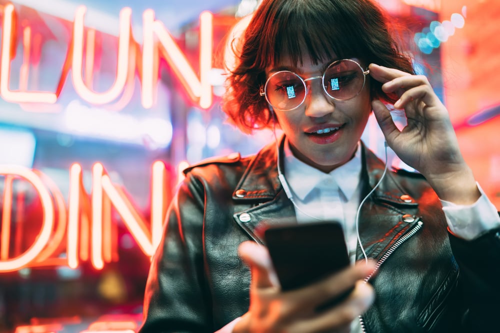 Young woman watches a video on her phone